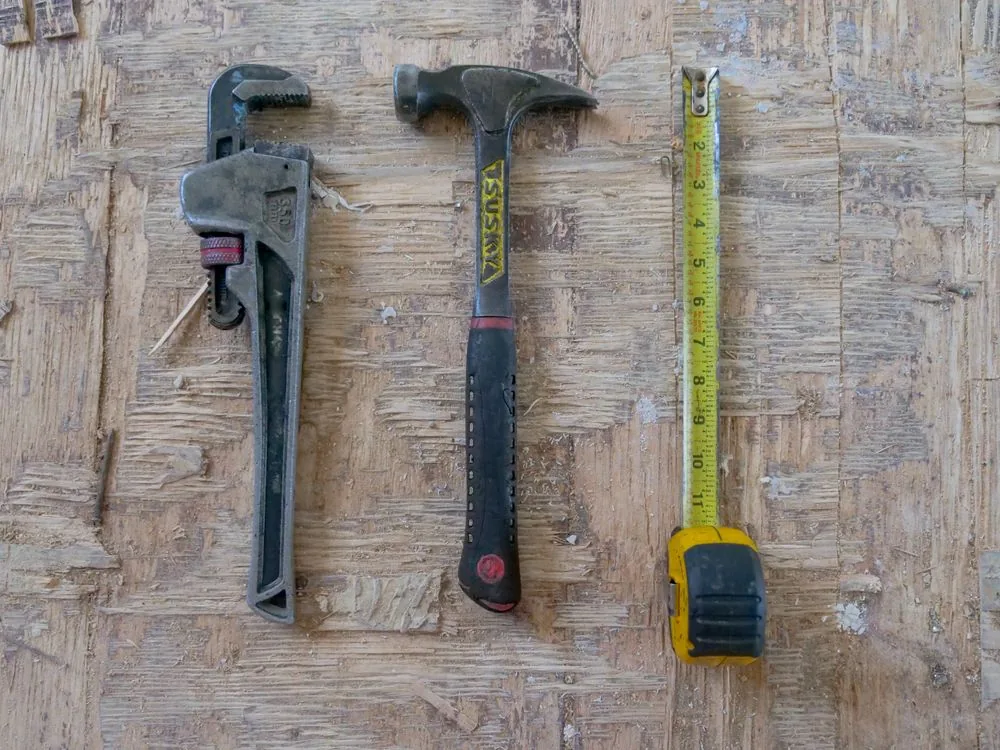 Hand tools organized on a workbench for repair and maintenance tasks