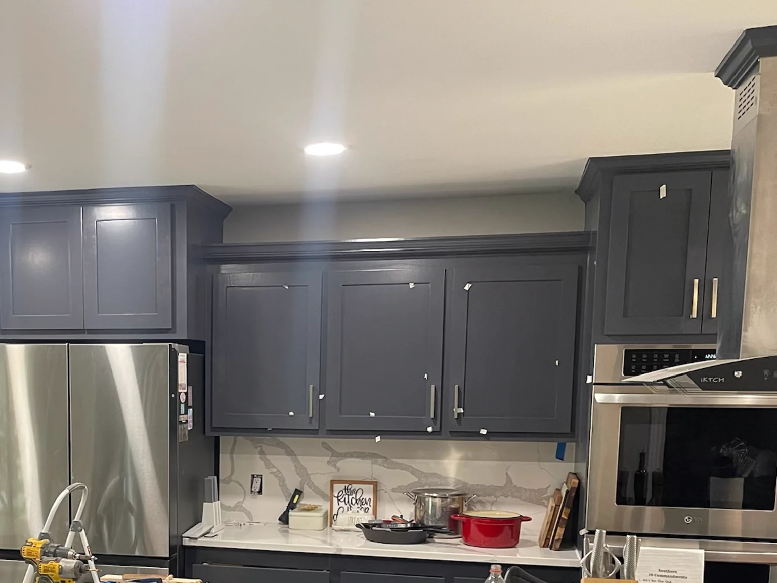 Newly built kitchen cabinetry finished in black paint by Guess Company