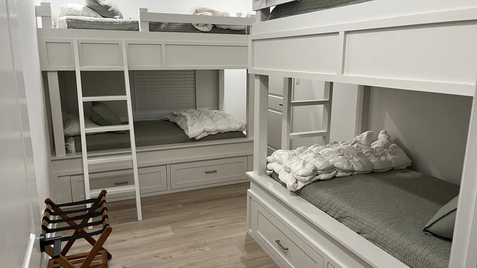 Finished custom bunk room with built-in beds and storage completed by Guess Company