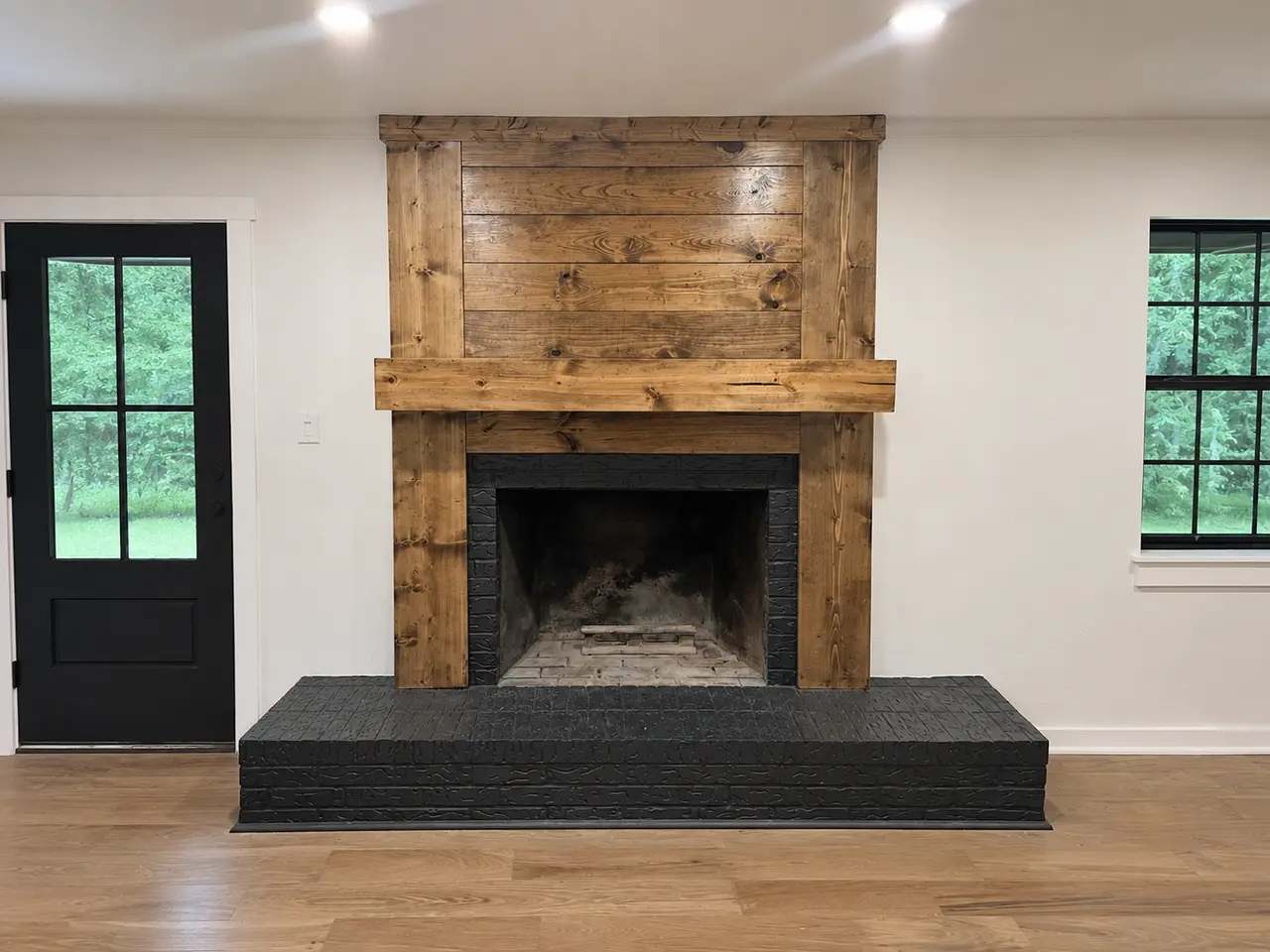 Custom wood fireplace surround and mantel built by Guess Company