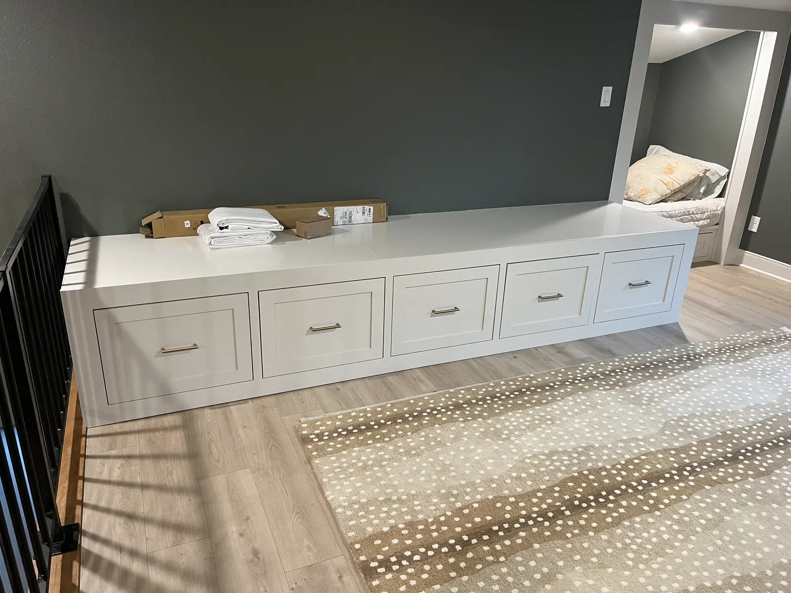 Custom wall-to-wall storage bench completed by Guess Company