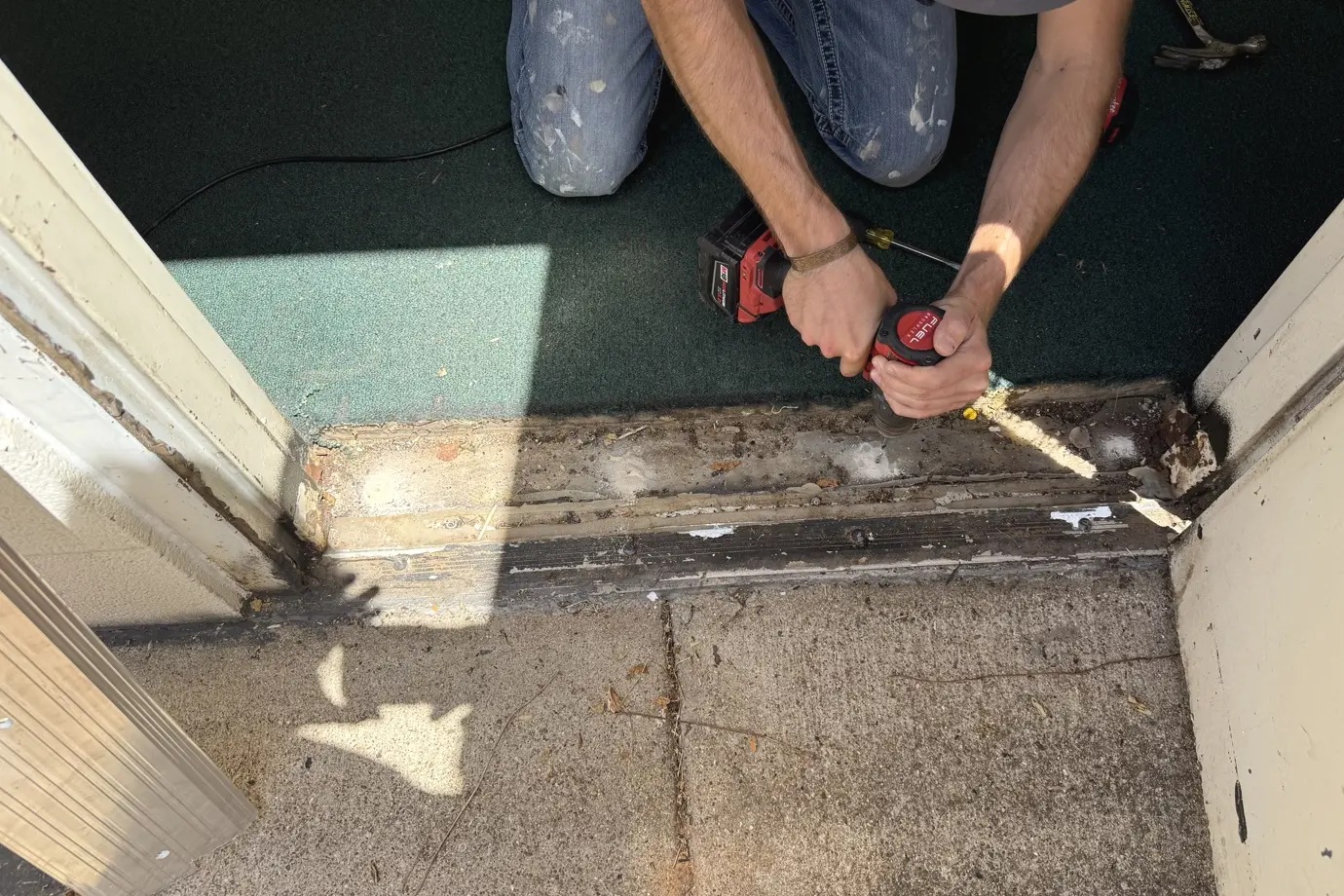 Guess Company repairing a worn exterior door threshold